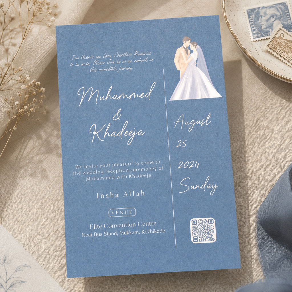 A blue wedding invitation card with white script text and a small illustration of a bride and groom, styled on a beige fabric surface with dried flowers, a ceramic dish, and a blue ribbon.