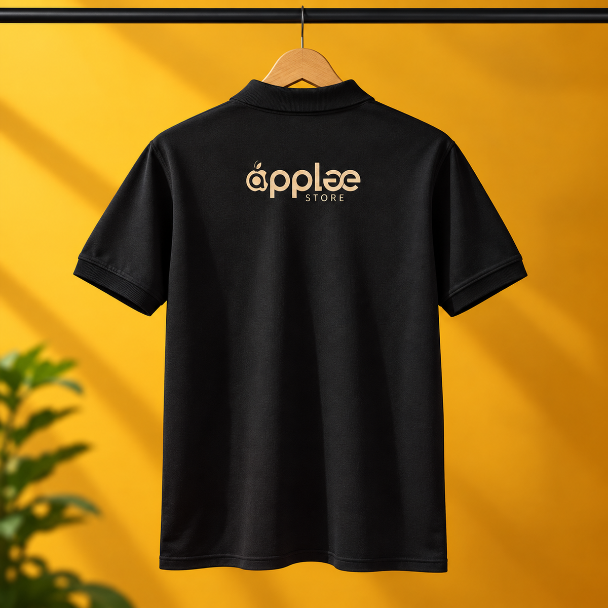 The backside of black apple store printed staff Uniform Tshirt hanging on a yellow background