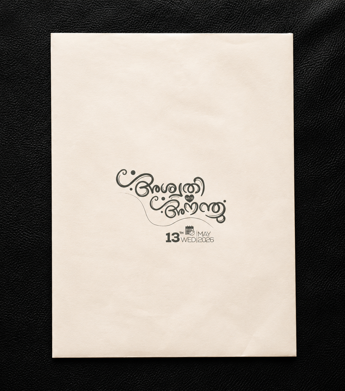 A cream-colored wedding invitation card featuring elegant black Tamil script and the text '13th May Weddings' displayed on a textured black background.