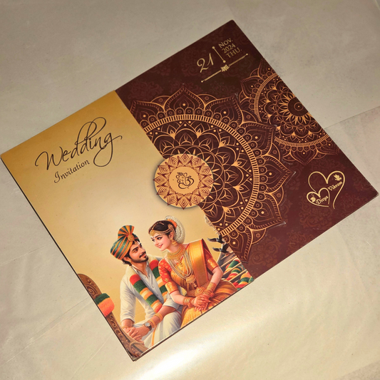 A square wedding invitation card featuring a gold and dark brown mandala design, with an illustration of a traditional couple at the bottom and the text 'Wedding Invitation' on a cream section.