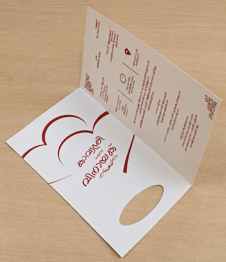 A white fold-out paper menu or booklet standing open on a light wood tabletop, with red printed graphics and text visible on both the cover and inner pages.