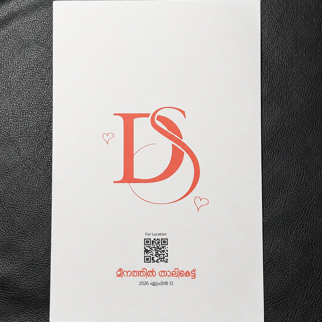 A white rectangular card or booklet with a red stylized 'DS' logo, small heart motifs, a QR code, and red text near the bottom, placed on a black textured surface.